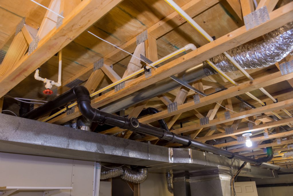 Framed home installation of air conditioner and heating ductwork in ceiling a new home HVAC