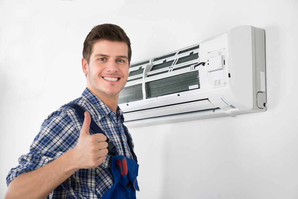 Young Happy Male Technician Gesturing Thumb Up